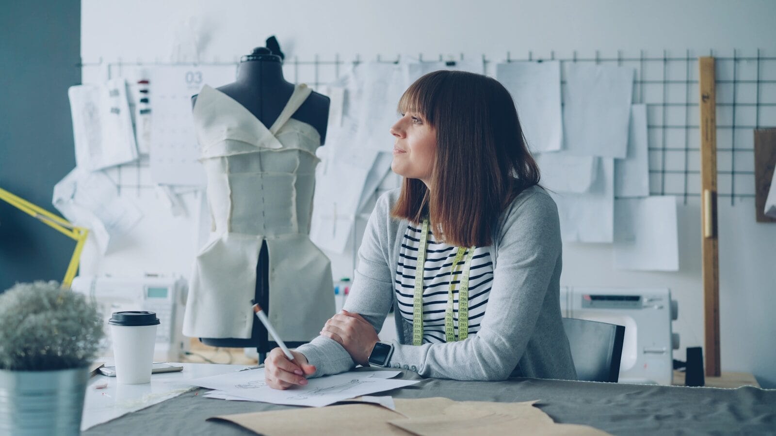 A fashion designer thoughtfully plans her next project.
