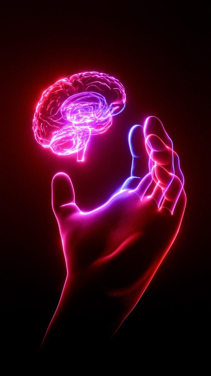 Why Traditional Planners Fail ADHD Brains 1 A person's hand holding a glowing brain model